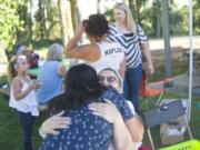 'I Have a Dream' alumni Veronica Beltran, left, hugs program sponsor Leslie Durst during the 20th anniversary picnic of the Southwest Washington 'I Have a Dream' on Friday evening, August 7, 2015 at Marine Park in Vancouver.