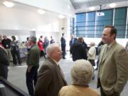 Clark County Commissioner Ed Barnes, center, chats Monday with Ridgefield City Manager Steve Stuart, right, whose resignation from the commission in the spring led to Barnes' appointment, at a going-away party for Barnes.