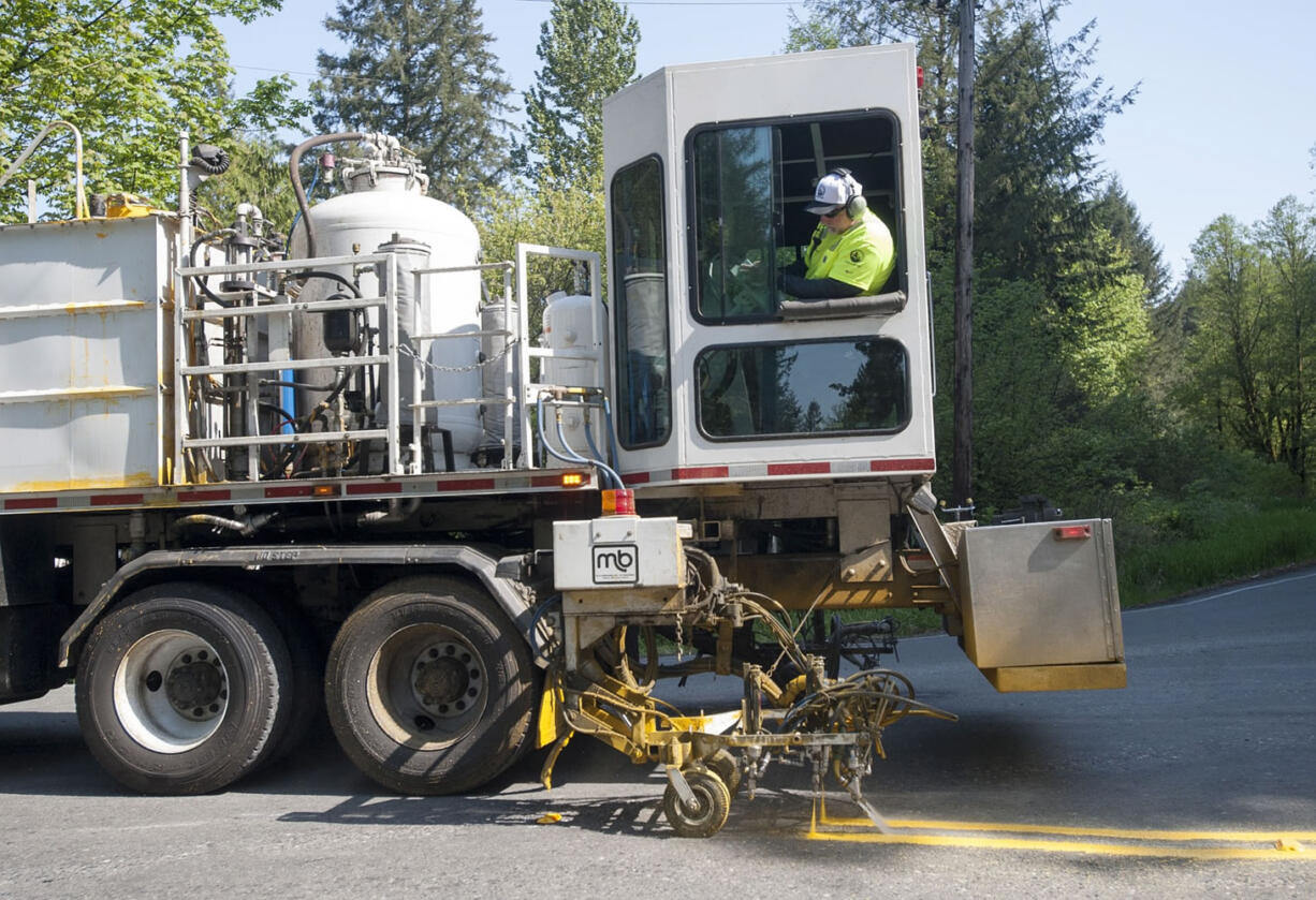 County workers restripe the roads surrounding Yacolt Mountain Quarry on April 30.