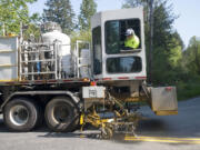 County workers restripe the roads surrounding Yacolt Mountain Quarry on April 30.