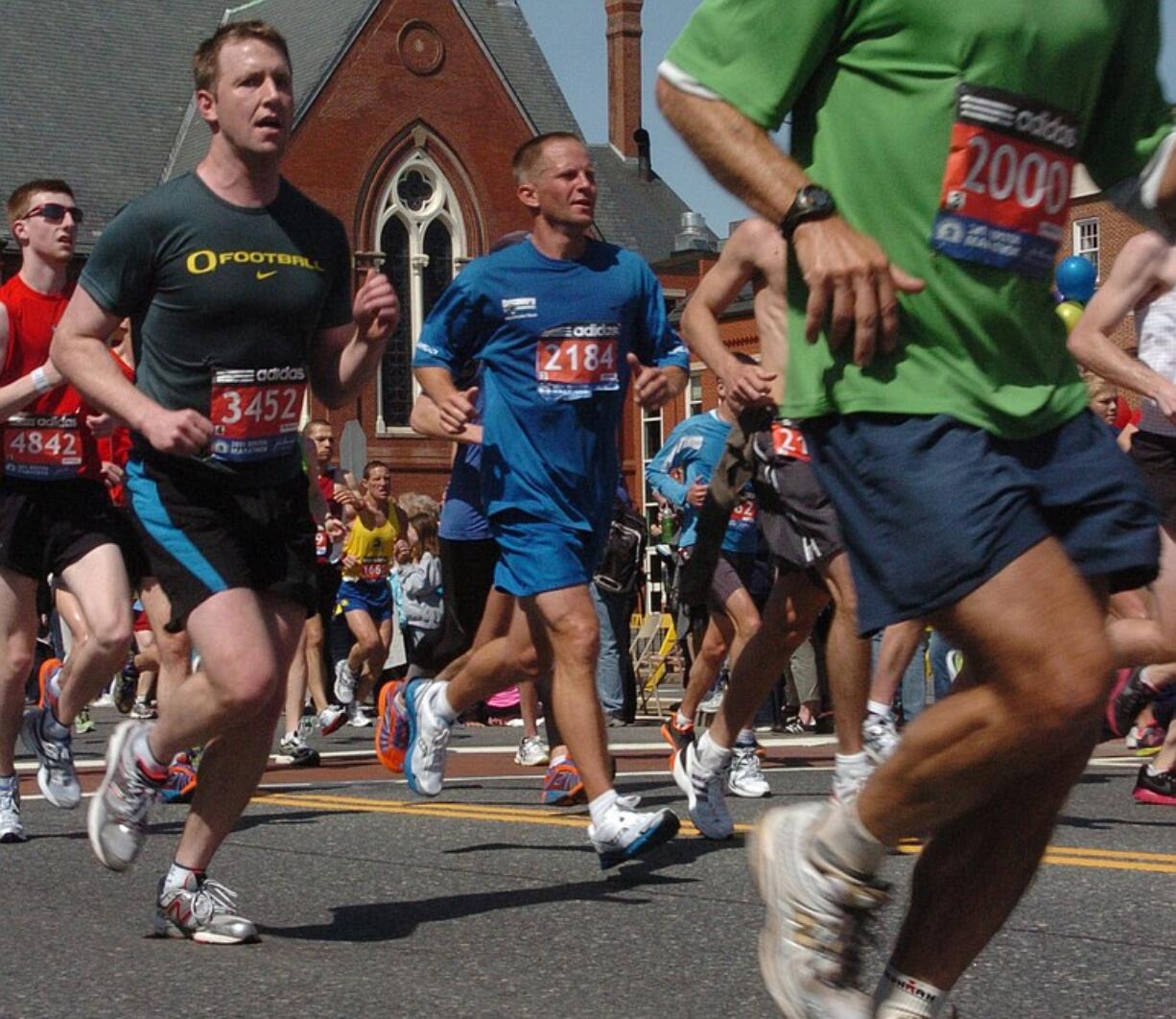 Columbian News Editor Micah Rice, left, runs in the Boston Marathon April 18.