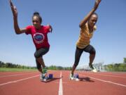 Union High School's identical twin sisters Dai'lyn, left, and Jai'lyn Merriweather shown, Thursday, April 30, 2015, are two of the top sprinters in the state.