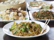 Chow mein with vegetables, crispy walnut prawns, chopped pepper hot chicken, green onion pancakes and steamed dumplings are served Oct.