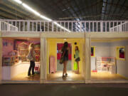 Visitors explore a life-size dollhouse at the interactive Toytopia exhibit at the Clark County Fair this week.