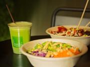 The mint limeade, left, the Buddha's Satay bowl, foreground, and the spicy Pangoa bowl are served at the Freshii restaurant in the Salmon Creek area.