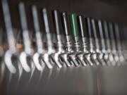 A long row of taps is seen at the new taproom Grapes 'n Growlers in east Vancouver.