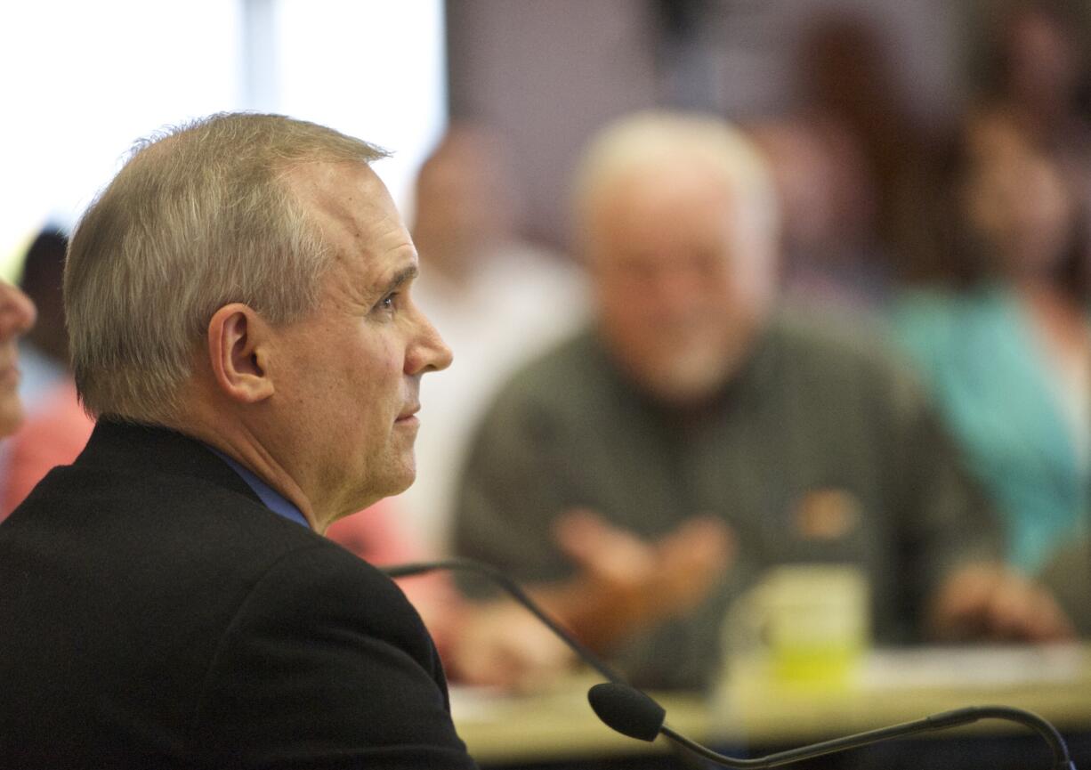 Clark County Commissioner David Madore listens to Linda Figg, CEO of FIGG Engineering Group, at a July 22 meeting on a proposed bridge in east Clark County.