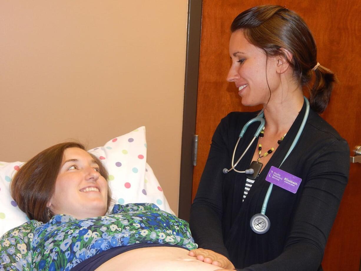 Photo courtesy of Pacific Midwifery
Certified nurse midwife Elizabeth Morales examines patient Angela George. Morales works through Pacific Midwifery Service in Salmon Creek.