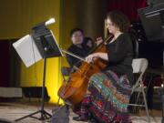 Cellist Betsy Goy, front, and pianist Michael Liu play Gypsy-style music Sunday afternoon at Kiggins Theatre in downtown Vancouver.