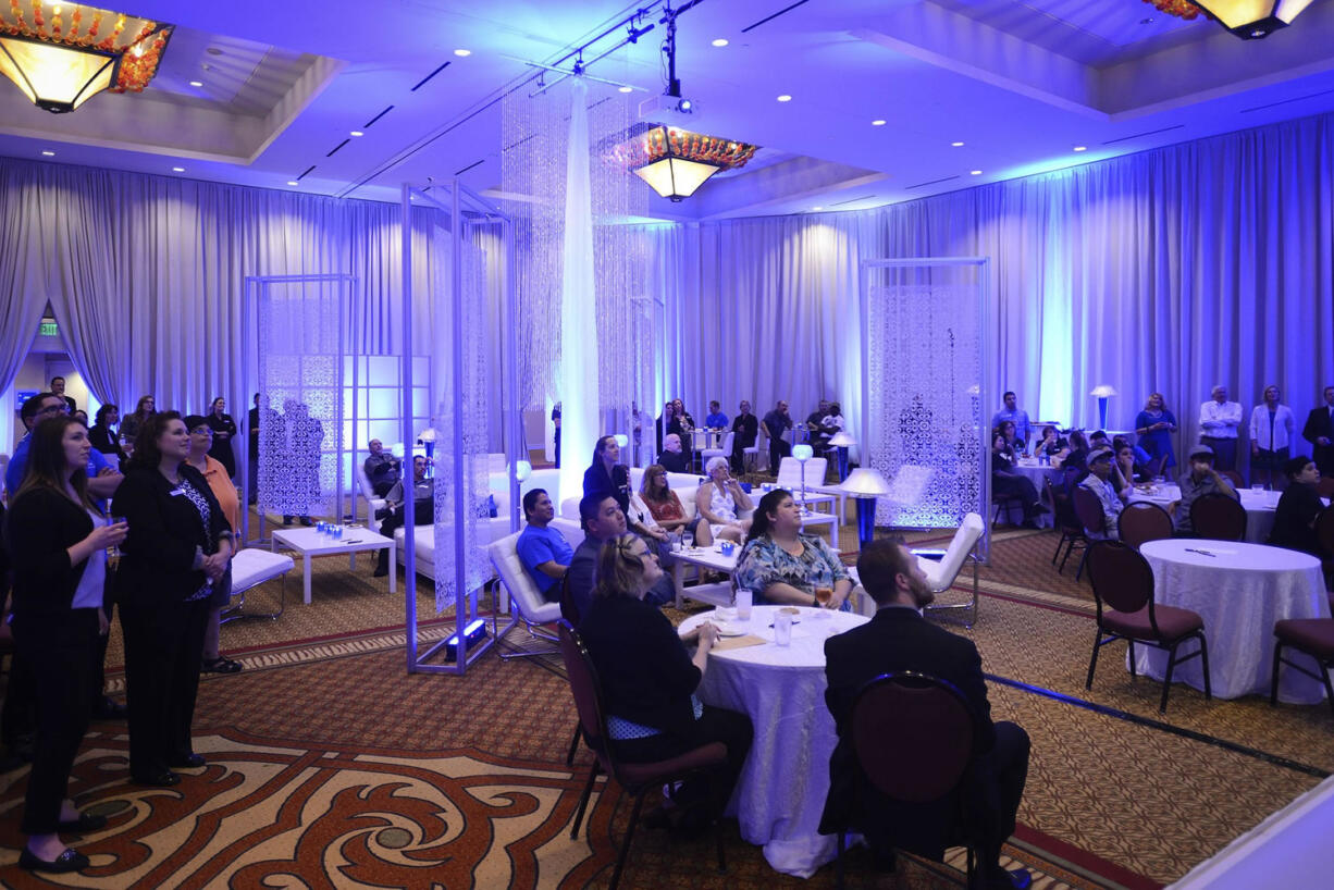 Employees gather Monday in the banquet room in celebration of the Hilton Vancouver Washington's 10-year anniversary.