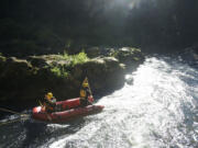 Rescue personnel from North Country EMS search the East Fork Lewis River below Moulton Falls Tuesday afternoon for a man presumed drowned.