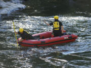 Rescue personnel from North Country EMS search the East Fork of the Lewis River below Moulton Falls on Tuesday for a man who drowned.