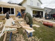 Volunteers work on a home addition for Brian and Jennie Epp recently in Battle Ground.