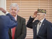 World War II veteran Fern Shaw, right, salutes Thursday in Washougal as he gets a Legion of Honor award from Jack Cowan, a French representative in Washington.