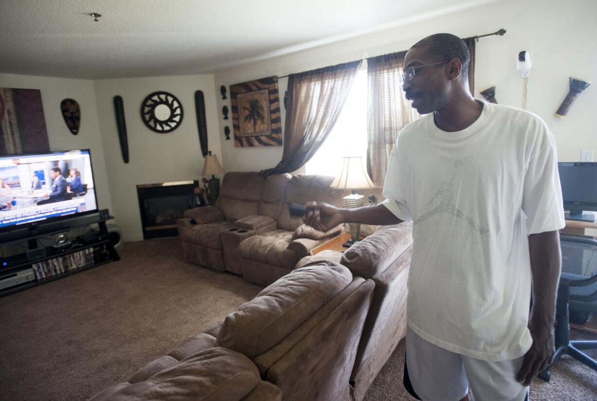 Robert Mitchell, who used to live at Courtyard Village Apartments and feared becoming homeless during the mass exodus there, shows visitors around his new two-bedroom apartment in east Vancouver, a Vancouver Housing Authority property called Orchard Glen.