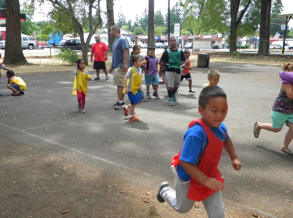 Children participating in the Summer Playgrounds Program play bear hunt at Evergreen Park.