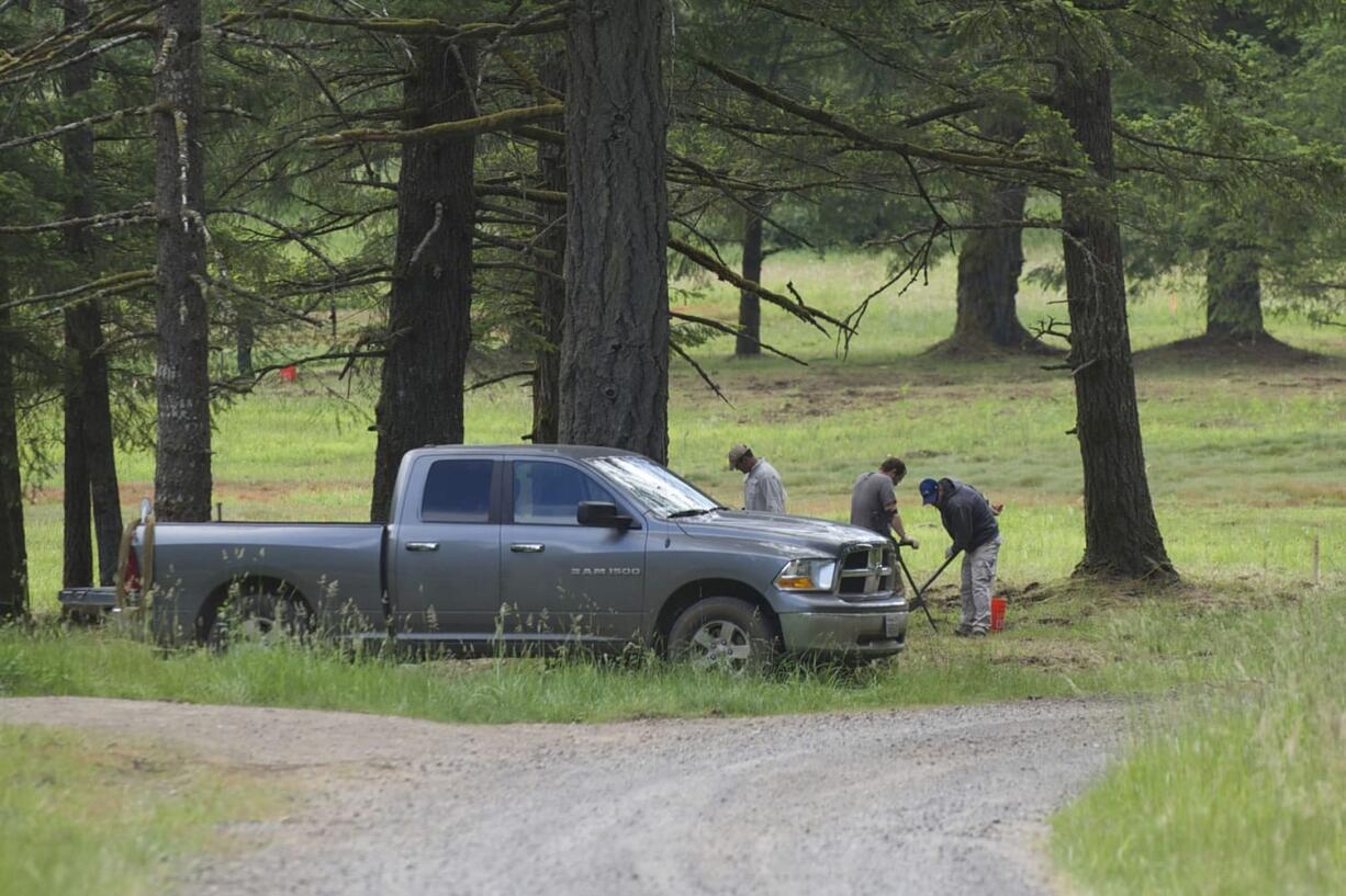 Cleanup crews search for buried munitions at Camp Bonneville on Thursday.