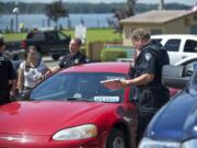 Police at the Port of Camas-Washougal collect evidence Wednesday from a vehicle that was driven by a man who allegedly tried to rob the 7 Market in Camas.