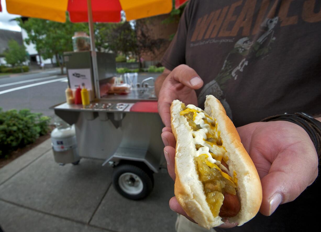 A green-chili dog is served July 3 at Black Dog Hot Dogs, a new Vancouver food cart.