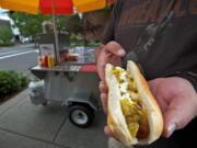 A green-chili dog is served July 3 at Black Dog Hot Dogs, a new Vancouver food cart.