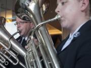 Kaylie Klicke, right, and her father, Ward Klicke, play instruments at a celebration of The Salvation Army's 125th anniversary.