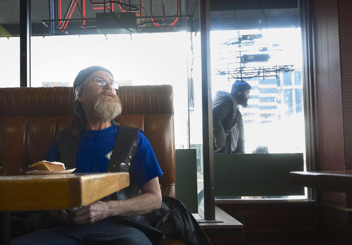 Gary Bennett, 55, of Vancouver, enjoys a slice of pumpkin pie after a complimentary Thanksgiving meal at Chronis' Restaurant and Lounge Thursday in downtown Vancouver.