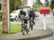 Friends Gary McCulley, 11, left, and Wyatt Varashupe, 10, ride their bikes to Walnut Grove Elementary School on Wednesday morning. The boys typically walk to school but decided to ride their bikes for National Bike to School Day.