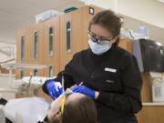 First-year dental hygiene student Mariya Kravchenka works on classmate Kiana Walker during clinical training at Clark College's Firstenburg Family Dental Hygiene Education and Care Center.