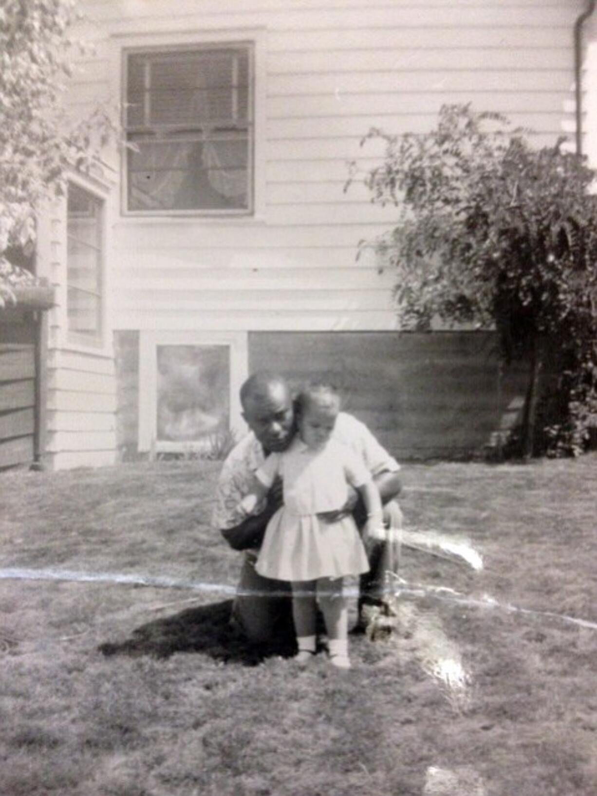 Marie Bruin kept this childhood photo of herself and her adoptive father on her desk at work.