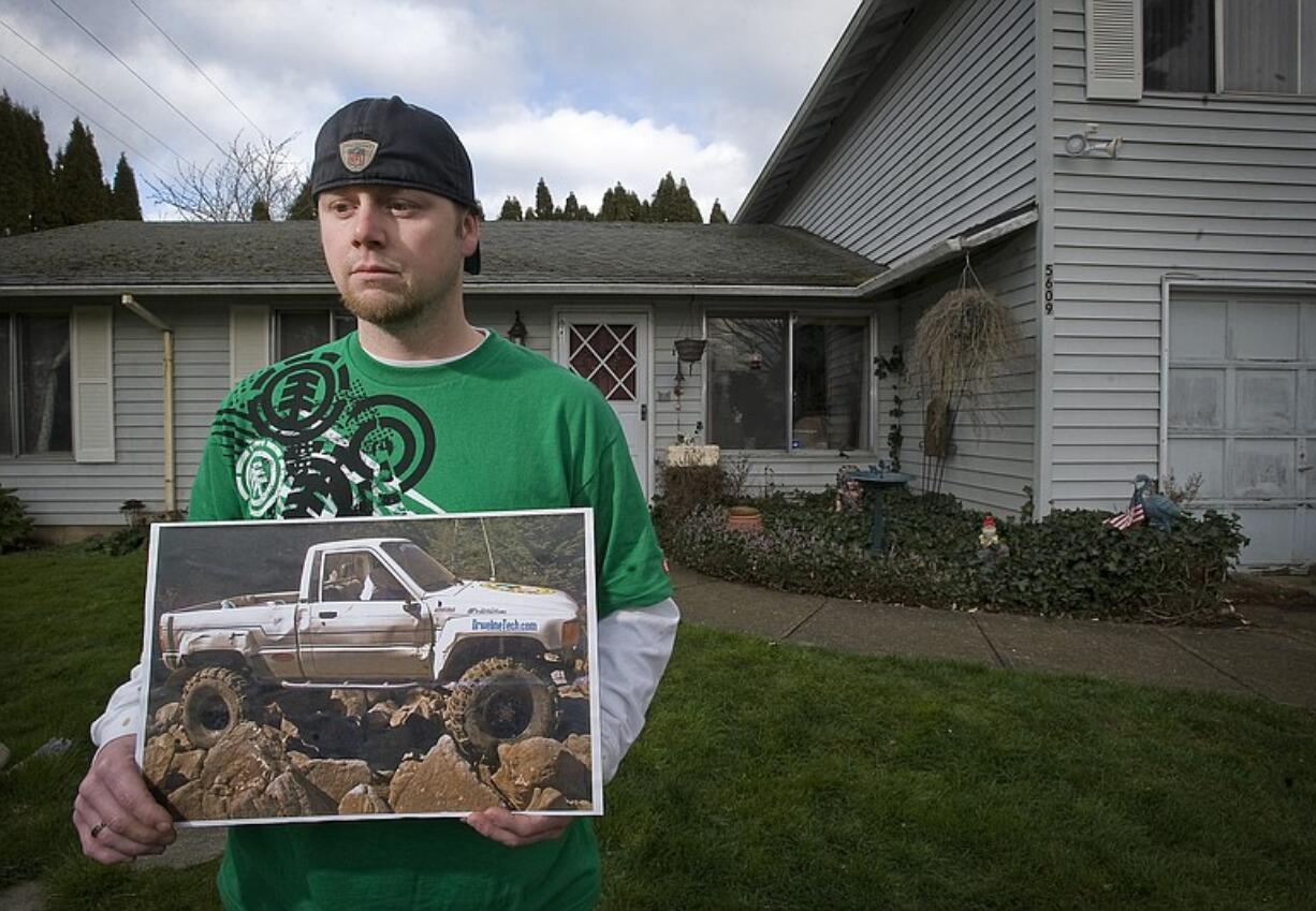 Darus Gieseman holds a photograph of his 1986 Toyota 4X4 truck, which was stolen from the backyard of his family's home earlier this month.