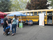 Mariah Bilby and her mother-in-law Diana Bilby donate school supplies at Stuff the Bus event at the Fisher's Landing Burgerville on Thursday.