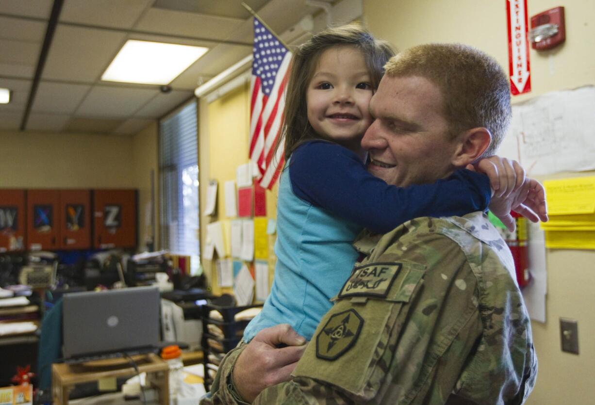 U.S. serviceman Williamraymond &quot;Bill&quot; Harris surprises his 4-year-old stepdaughter Ayrianna Lo in her Headstart classroom at Riverview Elementary School in Vancouver on Monday.