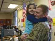 U.S. serviceman Williamraymond &quot;Bill&quot; Harris surprises his 4-year-old stepdaughter Ayrianna Lo in her Headstart classroom at Riverview Elementary School in Vancouver on Monday.