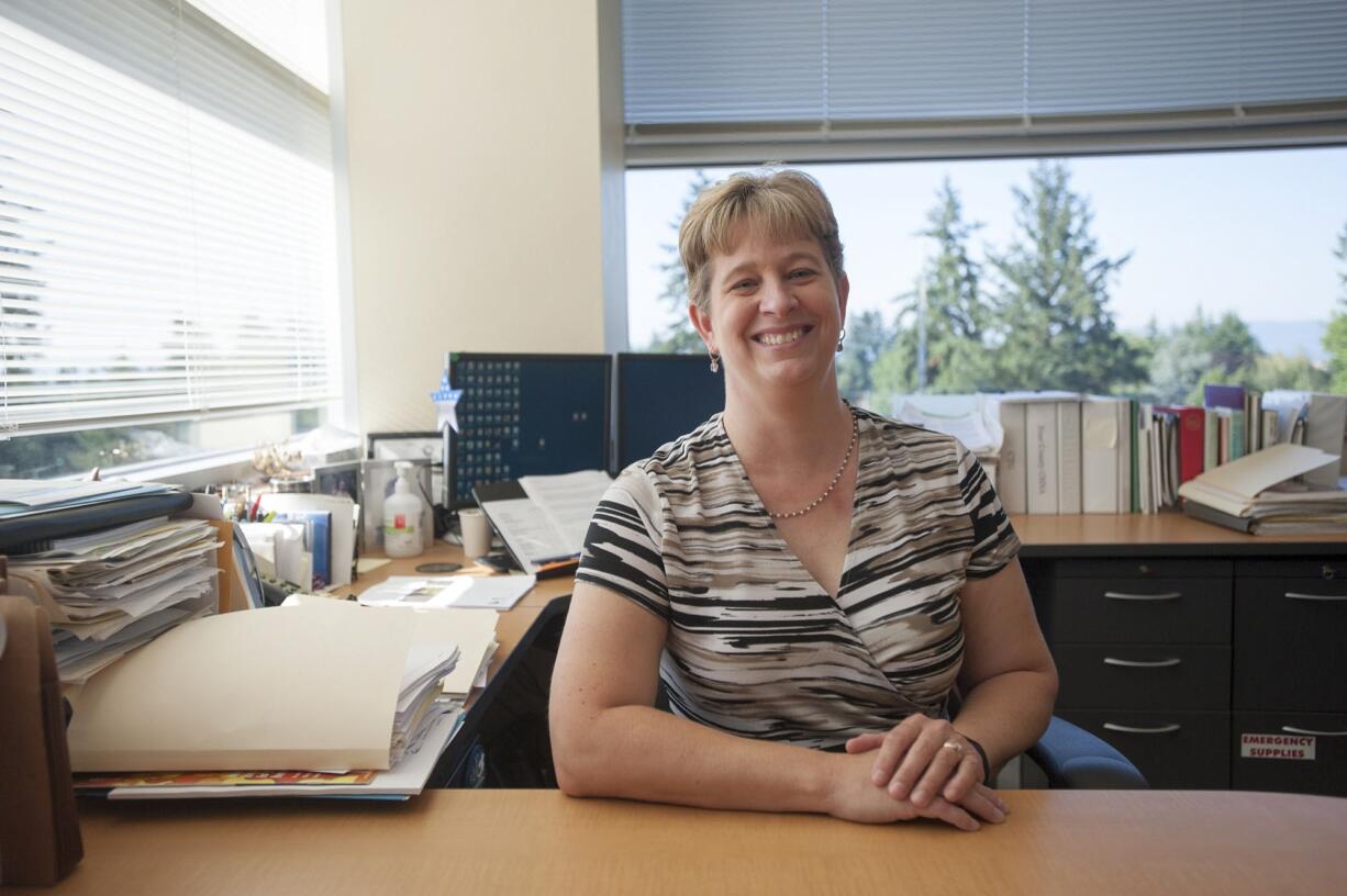 Melanie Payne, an epidemiologist for Clark County Public Health, sits in her office in the Public Health Building in Vancouver.