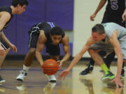 Columbia River's Nathan Hawthorne (1) steals the ball against Auburn's Tyler Pray (3) in the bi-district round of boys 3A basketball playoffs in Vancouver on Thursday.