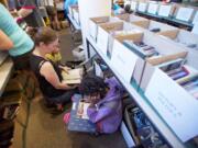 The Tsikayi family from Hockinson, from left, mom Chris, son Isaiah, 9, and Victoria, 10, were among the bargain-hunting bibliophiles at Bookfest '15, the Fort Vancouver Regional Library Foundation's summer super sale Friday.