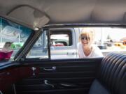 Amy Schlueter peeks inside a refurbished car Sunday at the Northwest Street Rod Nationals Plus Show at the Clark County Event Center at the Fairgrounds.