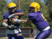 Running back Travon Santiago (L) and Quarter back Garrett McKee at a football practice at Columbia River High School in Vancouver Monday August 25, 2015.