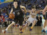 Micah Paulson makes a move to the basket as Union beats Issaquah 63-55 at the 2015 WIAA Hardwood Classic 4A Boys tournament at the Tacoma Dome, Thursday, March 5, 2015.