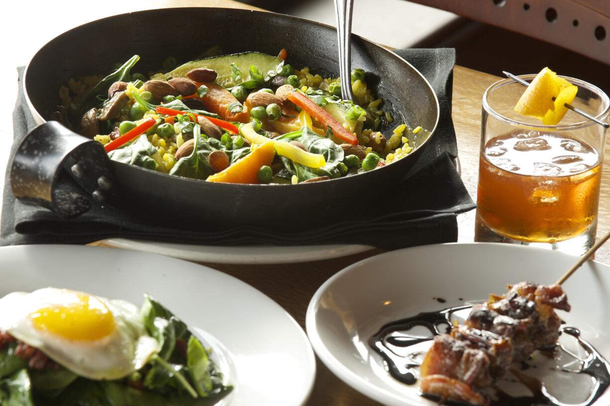 Garden paella, spinach salad and bacon-wrapped dates are served Feb.