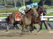 Keen Ice (7), with Javier Castellano, moves past Triple Crown winner American Pharoah, with Victor Espinoza, to win the Travers Stakes horse race at Saratoga Race Course in Saratoga Springs, N.Y., Saturday, Aug. 29, 2015.