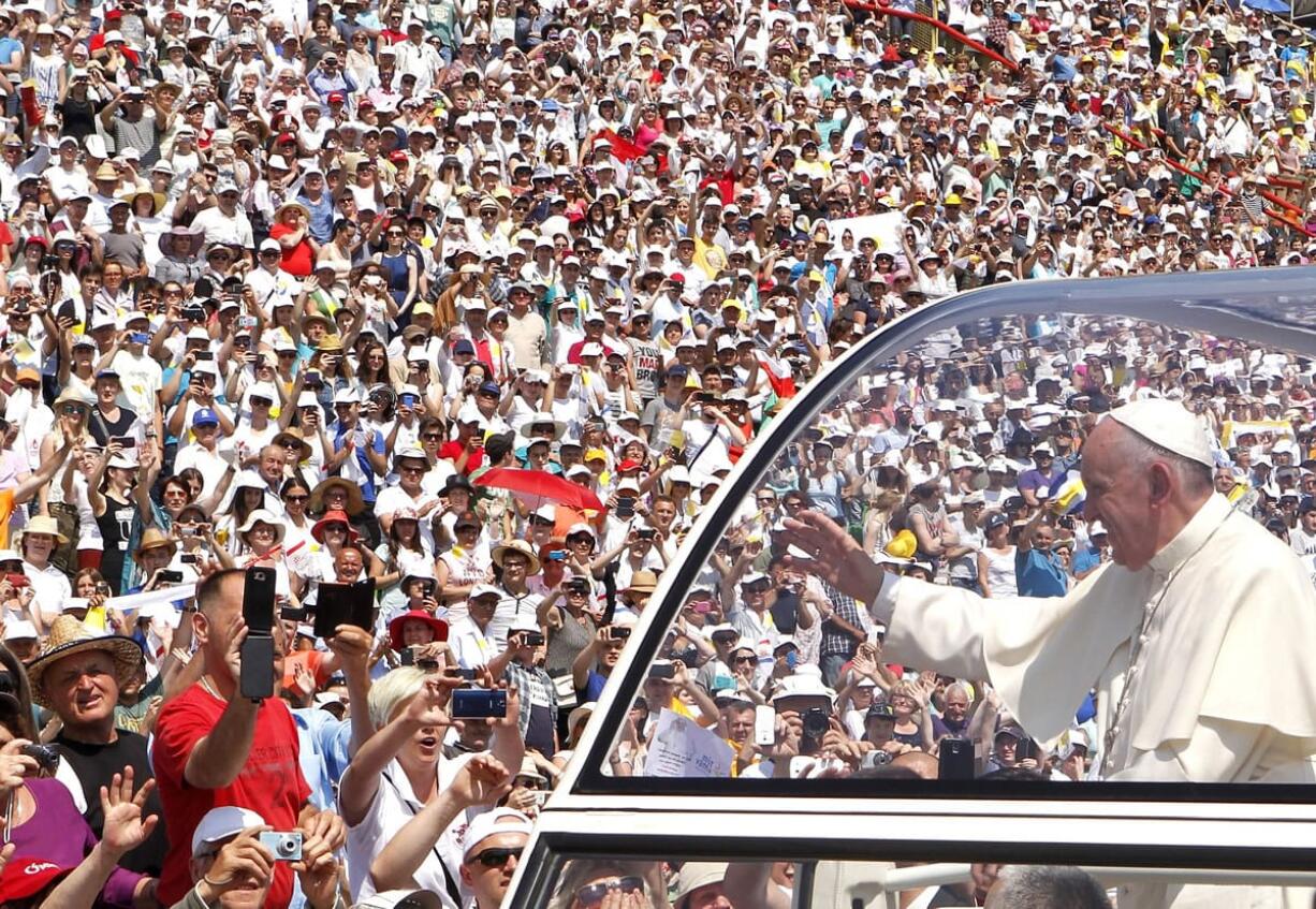 Pope Francis waves to the crowd Saturday as he arrives to celebrate a Mass at the Kosevo stadium, in Sarajevo, Bosnia-Herzegovina.