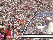 Pope Francis waves to the crowd Saturday as he arrives to celebrate a Mass at the Kosevo stadium, in Sarajevo, Bosnia-Herzegovina.