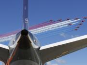 The Royal Air Force Red Arrows aerobatic display team perform a fly past Farnborough Airport on Monday to open the International Air Show, Farnborough, England.