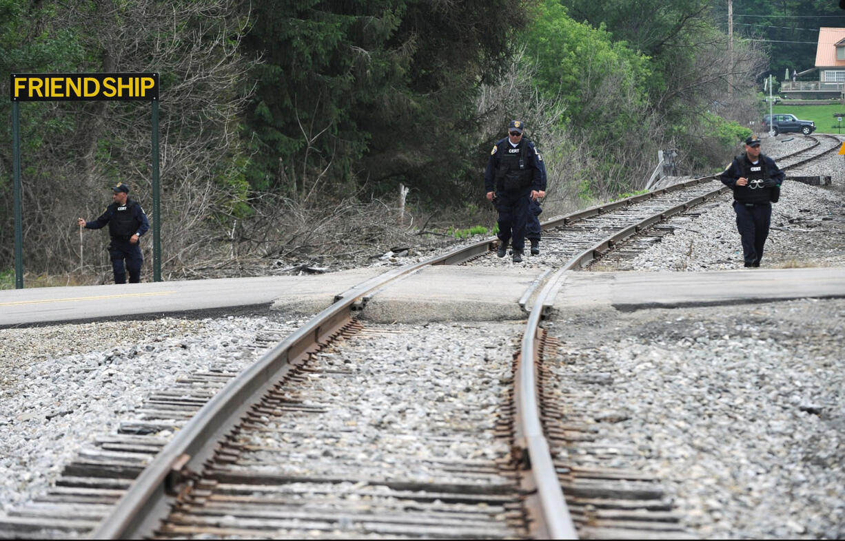 New York State Department of Corrections officers search the railroad tracks after a possible sighting of the two murder convicts who escaped from a northern New York prison two weeks ago, Sunday in Friendship, N.Y.