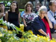 Zoo volunteer and &quot;big panda fan&quot; Mara Strock, right, wipes her eyes while listening to the news of the death of one of the new panda cubs during a news conference at the Smithsonian's National Zoo in Washington, Wednesday, Aug. 26, 2015.