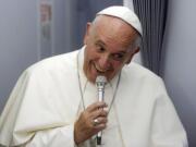 Pope Francis smiles as he meets the media during an airborne press conference aboard the airplane directed to Rome, at the end of his Apostolic journey in Ecuador, Bolivia and Paraguay.