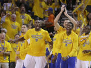 Golden State Warriors players react during the second half of Game 5 of the NBA basketball Western Conference finals against the Houston Rockets in Oakland, Calif., Wednesday, May 27, 2015.