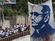 Pilgrims carry a portrait of Roman Catholic Archbishop Oscar Romero to Romero's beatification ceremony in San Salvador, El Salvador, Saturday, May 23, 2015. Romero was beatified by Roman Catholic officials in a ceremony elevating the once-controversial cleric to the ranks of the blessed 35 years after his assassination.