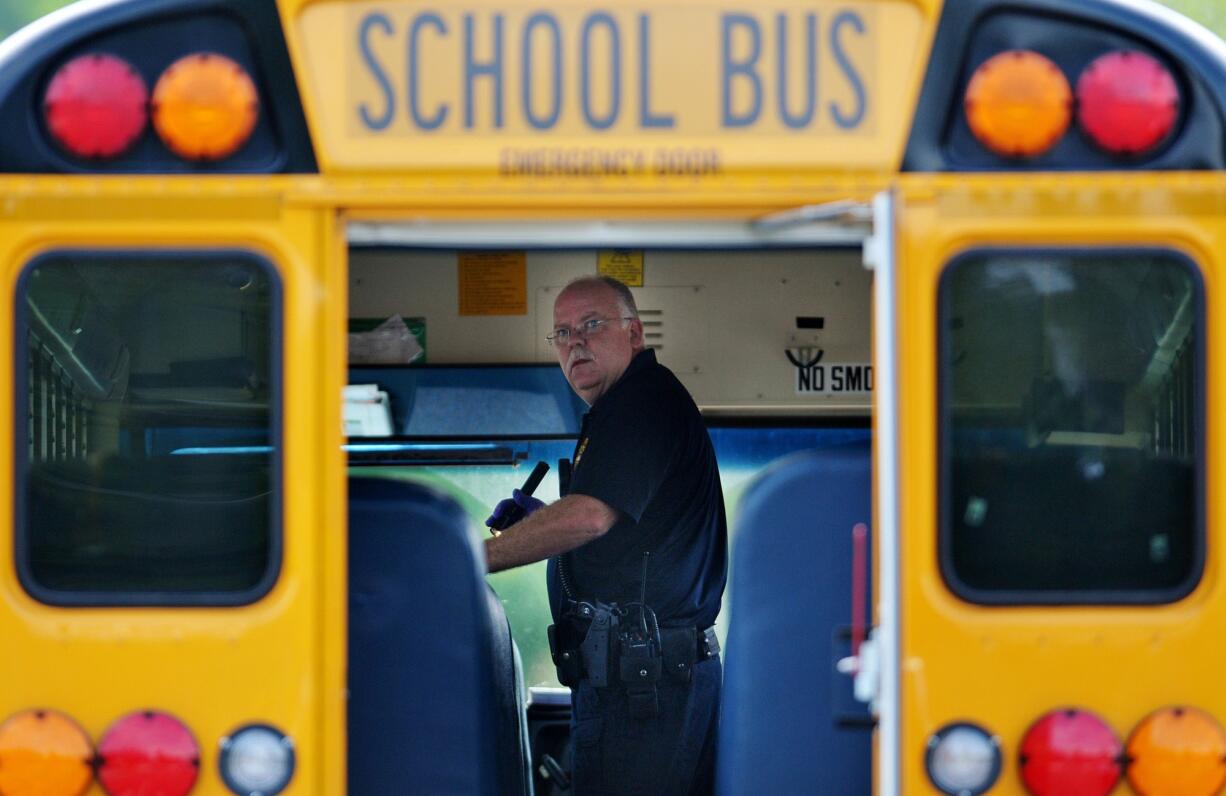 Police investigate the scene of a shooting involving a school bus Thursday in Jacksonville, Fla.